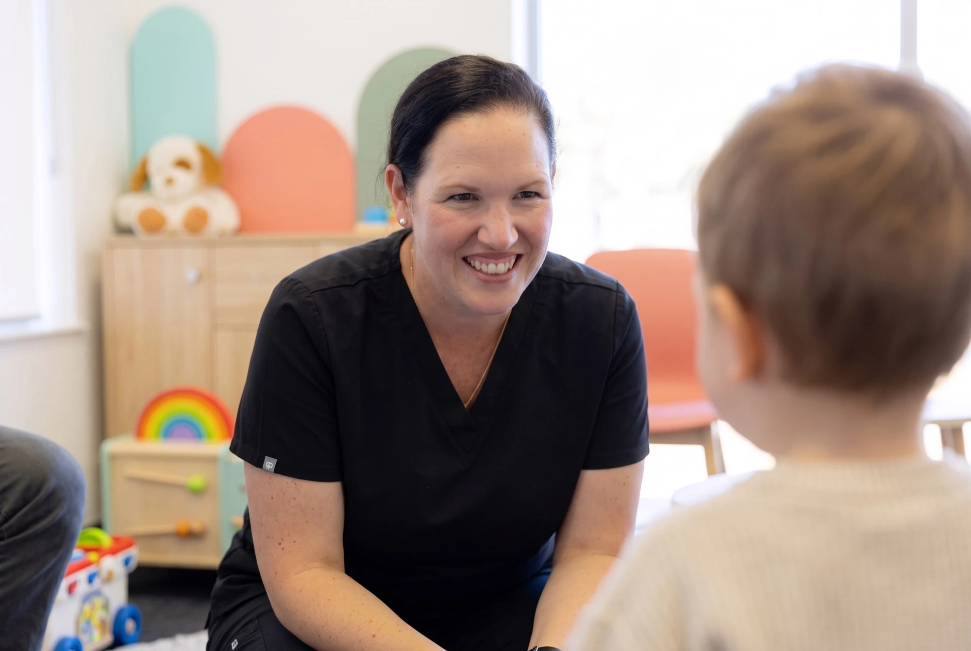 Dr O’Reilly chatting with a toddler in the clinic playroom