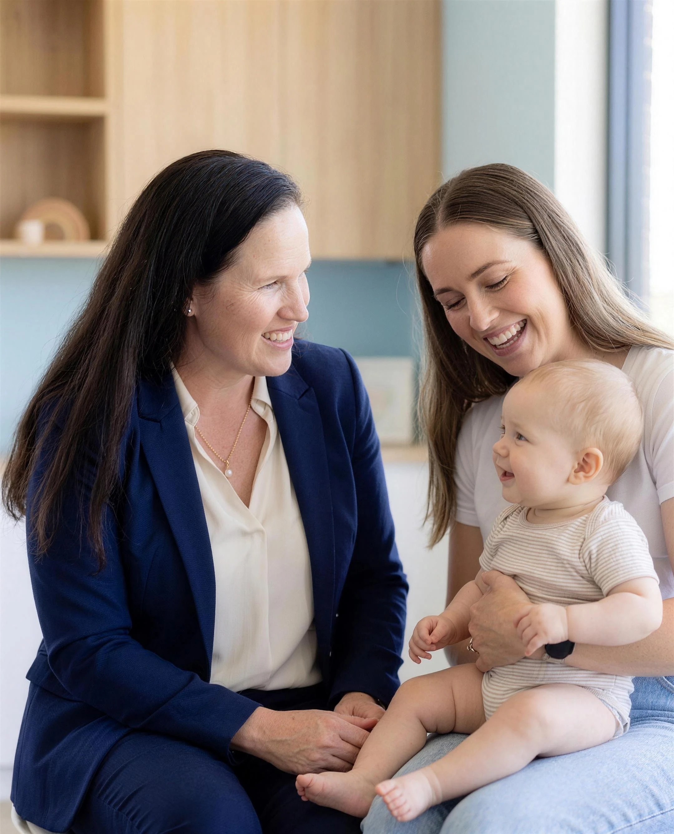 Dr O’Reilly in warm conversation with a mother holding her baby